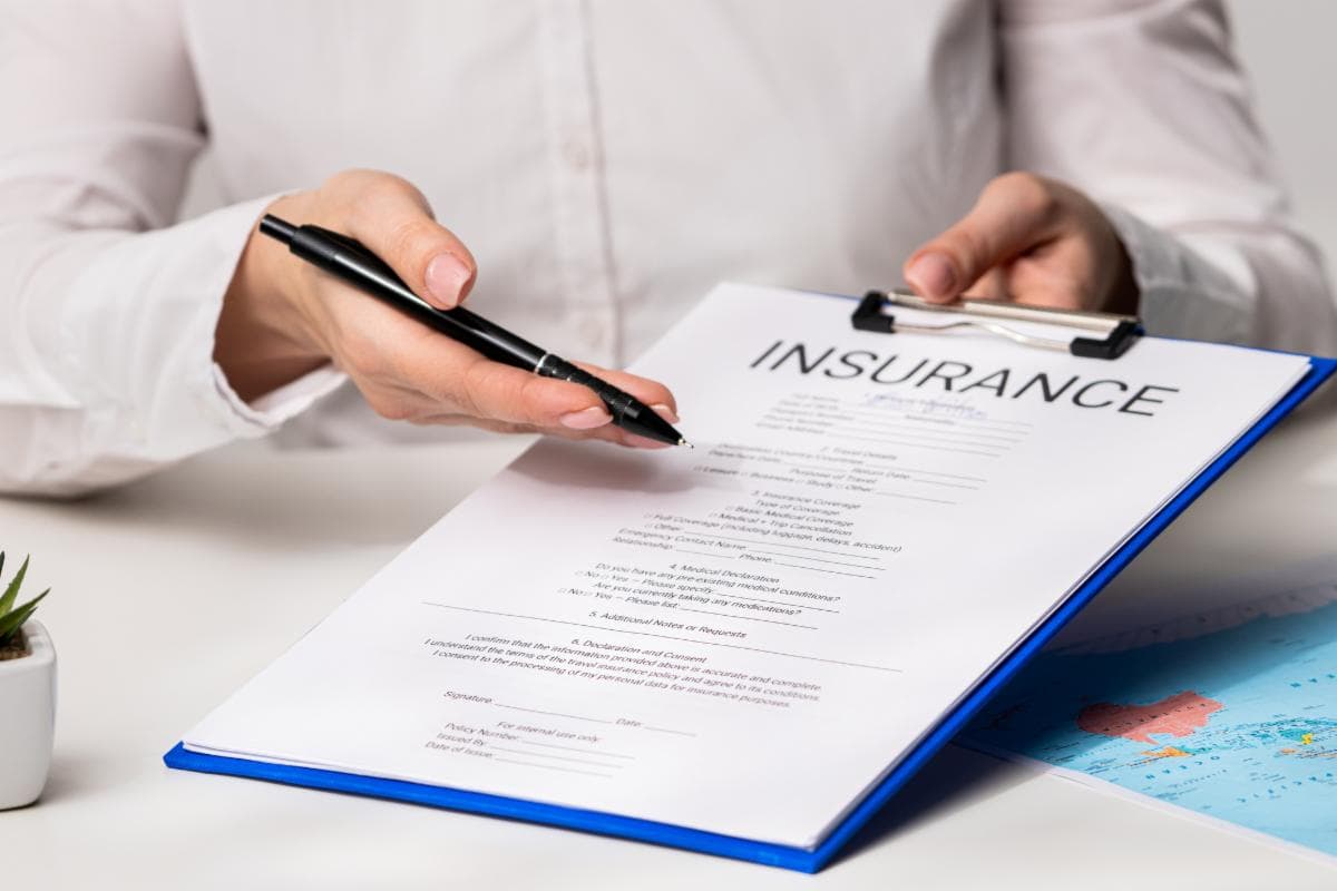 Hands holding an insurance form on a clipboard